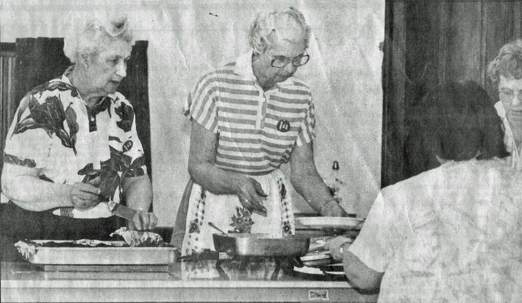Sharing Kitchen volunteers serving meals in 1986
